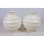 Pair of Keith Murray for Wedgwood off white Globe vases, with ribbed circular bodies,