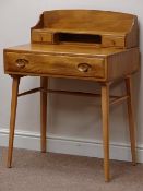 Ercol 'Windsor' light elm desk, drawer, and two raised drawers, tapering splayed legs, W69cm, H95cm,