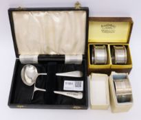 Baby's hallmarked silver spoon and pusher and three napkin rings all boxed approx 3.