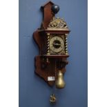 Dutch style wall hanging clock, with Atlas figure, striking the hours and halves on bell, H50cm