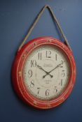 Circular wall clock in red surround with rope hanging, inscribed 'London 1865',