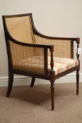 Edwardian beech Regency style bergere armchair with caned back and sides on fluted tapered supports