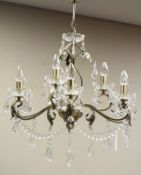 Bronzed metal and glass nine branch chandelier with cut glass drops Condition Report
