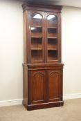 Victorian mahogany bookcase on cupboard, two arched glazed doors, W86cm, H214cm,
