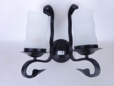 Set of eleven black finish wrought metal single branch light fittings with opaque glass shades,