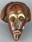 Tribal Masks; West African carved wood and rope work mask highlighted Kaolin pigment,