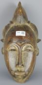 Tribal Masks; West African carved wood mask, traces of Kaolin pigment,