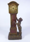20th century patinated spelter model of a Dutch boy with a long case clock,