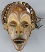 Tribal Masks; West African Côte d'Ivoire carved wood mask with traces of Kaolin white pigment,