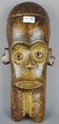 Tribal Masks; West African carved wood mask of a elongated face,