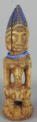 Yoruba male Ibeji Nigeria twin figure with blue beaded necklace and blue pigment,