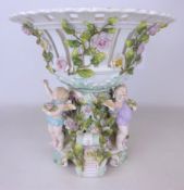 19th/ early 20th Century Sitzendorf porcelain centrepiece supported by three cherubs, H30.