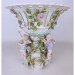 19th/ early 20th Century Sitzendorf porcelain centrepiece supported by three cherubs, H30.