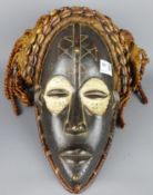 Tribal Masks; West African Côte d'Ivoire carved wood mask with traces of Kaolin white pigment,