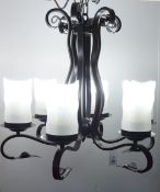Black finish wrought metal six branch light fitting with opaque glass shades,