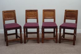 'Gnomeman' oak set four dining chairs, adzed panelled backs, upholstered seats,