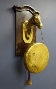 Early 20th century oak & brass dinner gong, horse head support engraved 'Grand Parade,