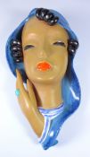 Goldscheider pottery wall mask, modelled as a lady in blue scarf with black curled hair,