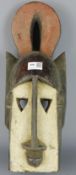 Tribal Masks; West African carved wood mask, highlighted with white and red pigment,