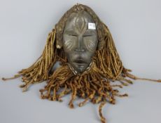 Tribal Masks; West African, probably Côte d'Ivoire carved wooden mask with rope work,