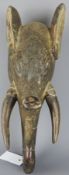 Tribal Masks; West African carved wood mask/ helmet crest in the form of an elephant,