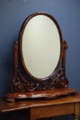 Victorian mahogany oval swing dressing table mirror, moulded serpentine base, with carved horns,