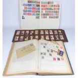 Two albums of Victorian and later world stamps and a album of early 20th Century cigarette cards