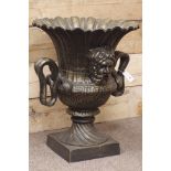 Large bronze finish circular pedestal urn, wavy border, twin snake handles, mask features, W62cm,