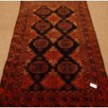 Beluchi rug, repeating Guls on dark blue field,