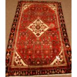 Persian Shiraz red ground rug, stylised Herati design,