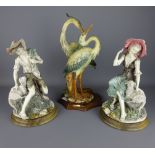 Pair of Capodimonte figure of a Shepherd and Shepherdess and a model of two herons,