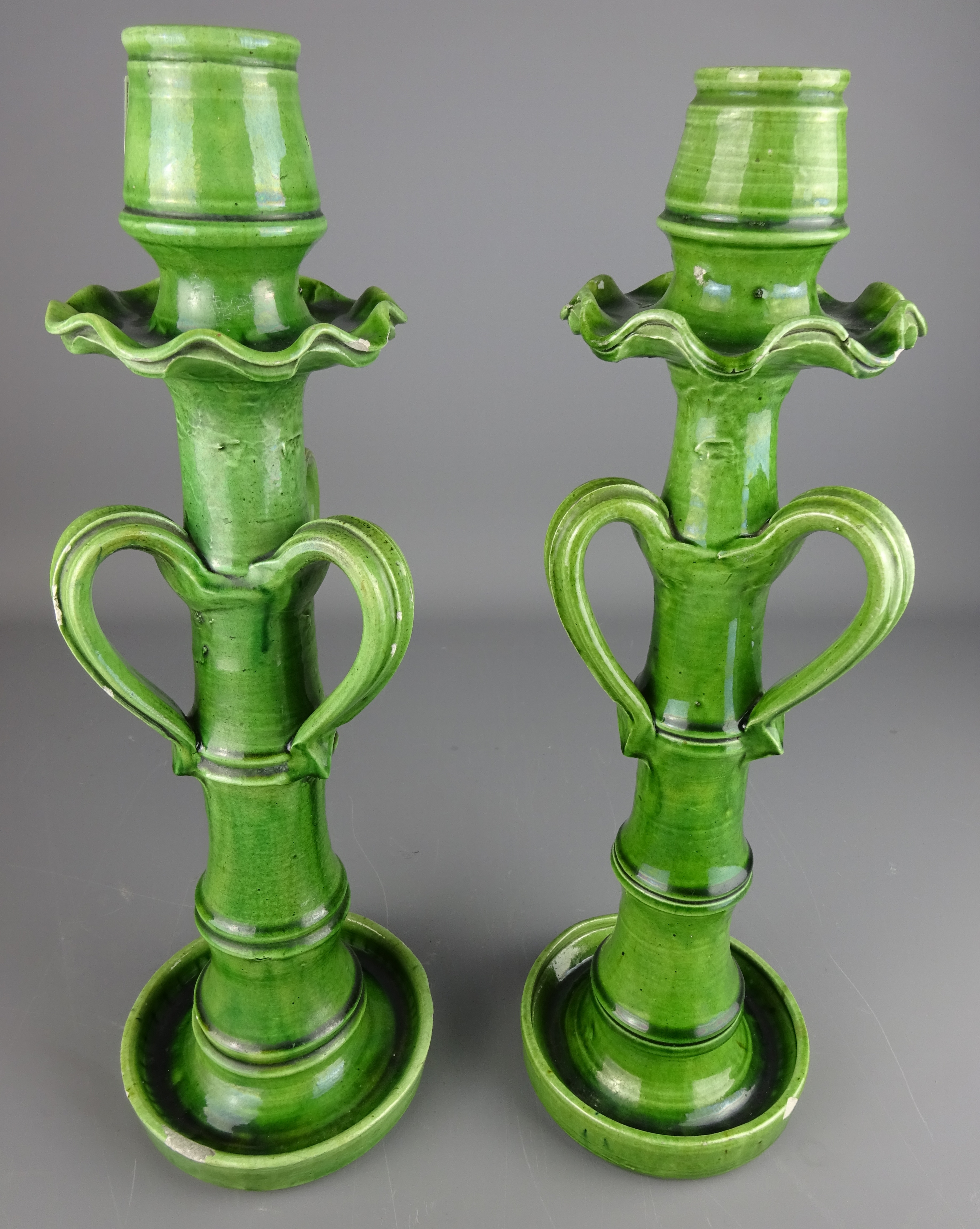 Pair of tall Arts and Crafts green glaze candlesticks with bamboo shaped stems,