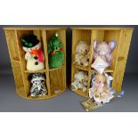 Two Merrythought Christmas teddies and five other small Merrythought bears on two wooden stands