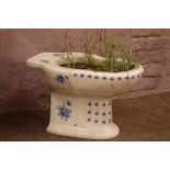 Victorian style blue and white decorated toilet basin planted with shrubs