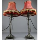 Pair of Victorian bronze candlesticks on lion paw feet, converted to table lamps, H29.