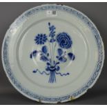 Late 18th / early 19th Century Delft dish with raised central boss and floral decoration. Dia.