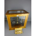 Chemical balance by Griffin and George ltd in golden oak glazed case and a set of cased weights (2)