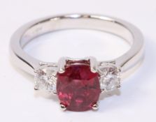 Oval ruby and round brilliant cut diamond three stone white gold ring hallmarked 18ct,