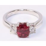 Oval ruby and round brilliant cut diamond three stone white gold ring hallmarked 18ct,