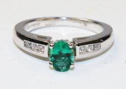 18ct white gold oval emerald and channel set diamond ring hallmarked - emerald approx 1 carat