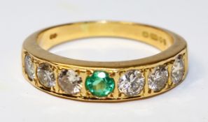 18ct gold ring set with six diamonds and a central emerald hallmarked