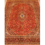 Persian Kashan red ground rug carpet, interlacing foliage with central medallion, repeating boarder,