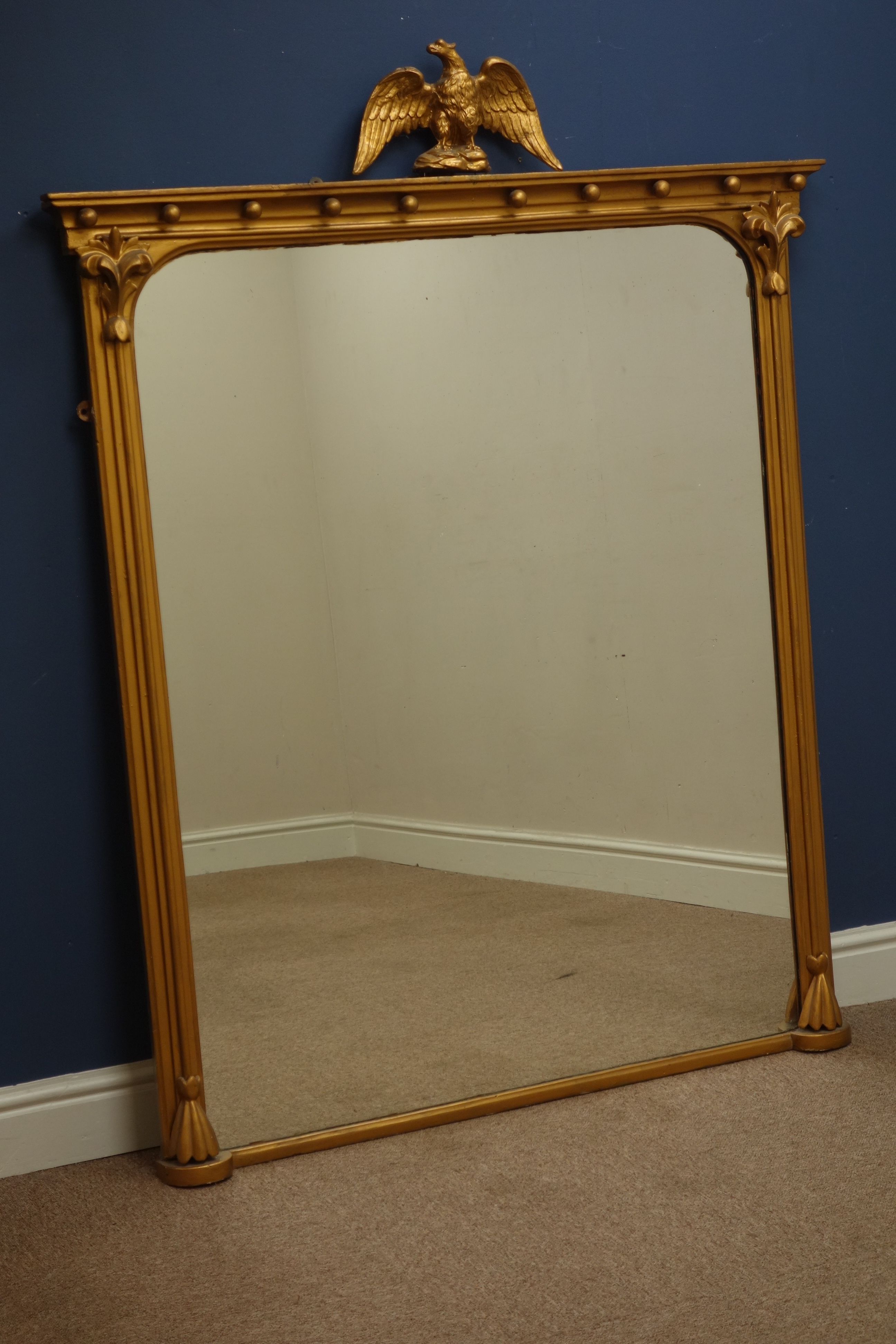 Regency style giltwood over mantel mirror, ball cornice with eagle finial and leaf carved capitals,