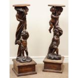 Pair 19th century carved beech putti torchère stands, with later plinths and tops,