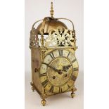 18th Century brass lantern clock with strap work bell supports, pierced frets and Roman chapter,