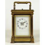 Late 19th century brass repeater carriage clock, four turned column supports, dentil cornice,