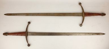 Pair of ornamental Spanish type swords with leather bound grips, 69cm blades engraved Toledo,