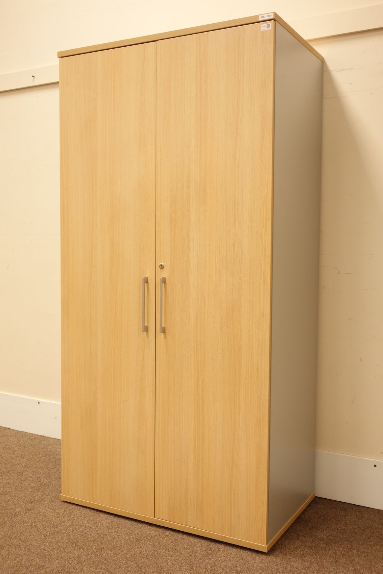 (STK10108) Large deep light oak finish lockable two door office uniform/storage cabinet fitted with