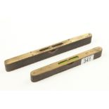 Two brass topped ebony levels,