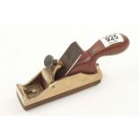 A chunky brass sole plane with one sole and cutter G+